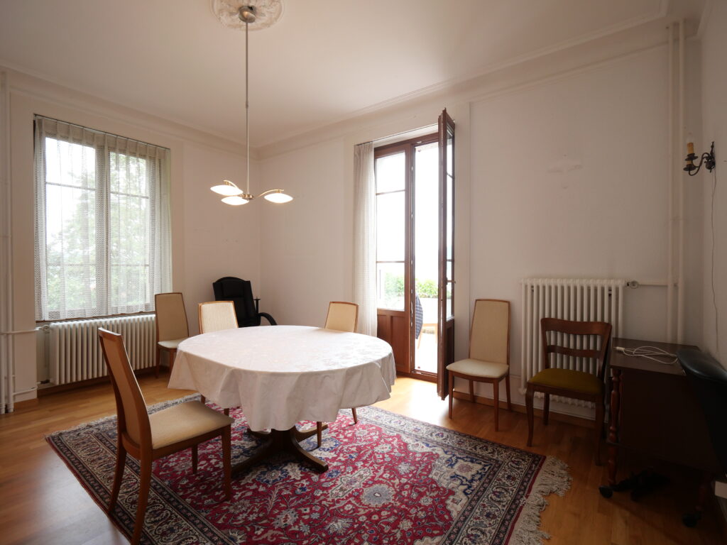 Wohnzimmer / Esszimmer des zu verkaufenden Hauses mit Blick auf den Genfersee.